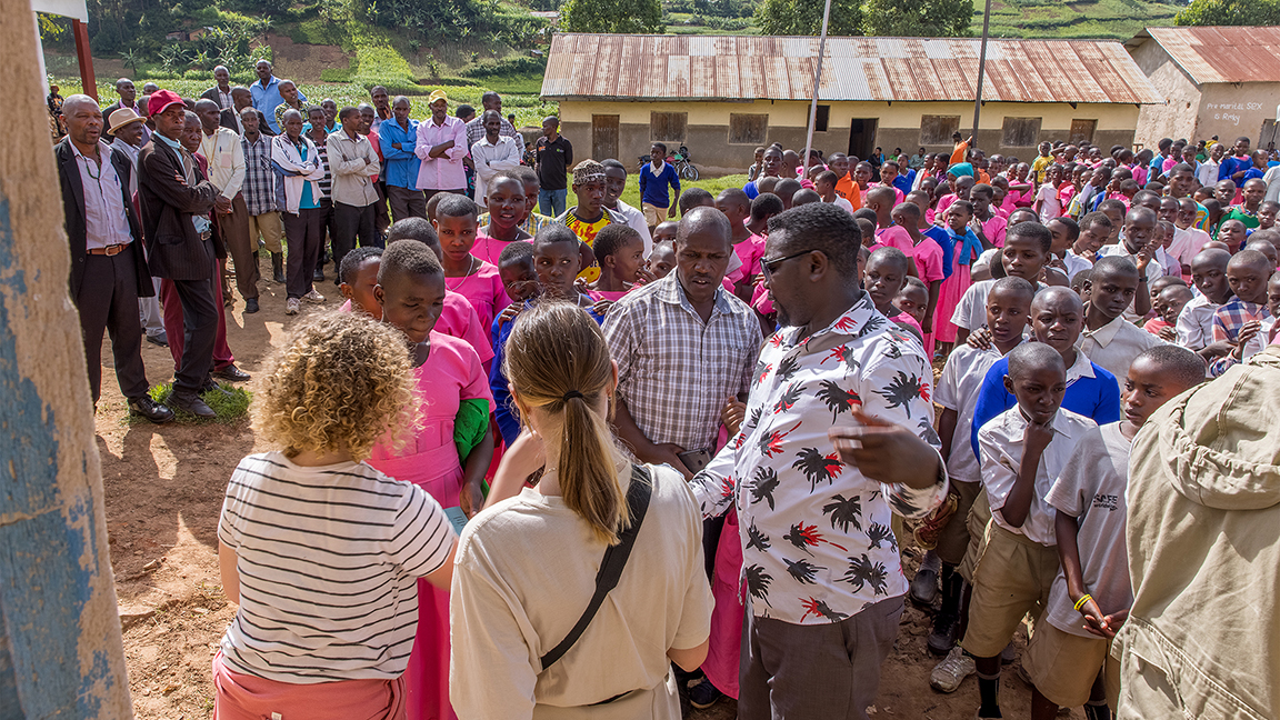 Volunteers at Twende Community Project, giving out free aid at Kabaya Primary School